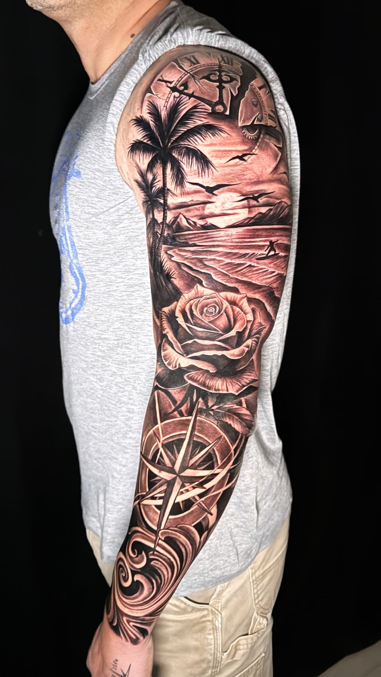 Full sleeve with clock, palms, beach, rose and compass in black and grey