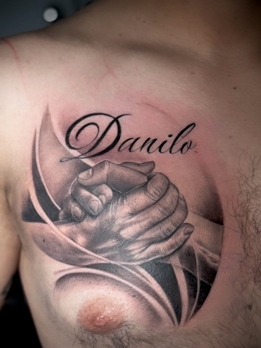 Memorial chest piece with clasped hands and lettering