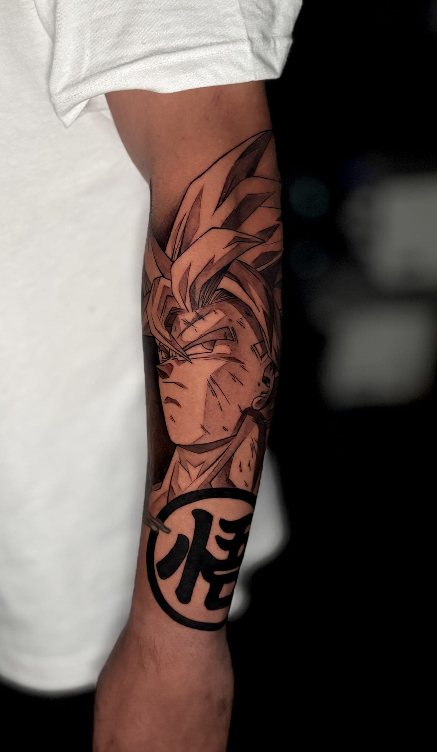 Anime character Goku forearm tattoo
